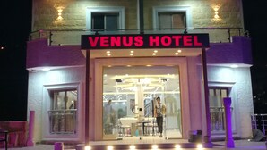 A multi-story building with a sign reading "VENUS HOTEL". - Petra Venus Hotel (Wadi Musa)