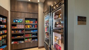 A well-lit grocery section with refrigerated display cases and shelves stocked with snacks and beverages.