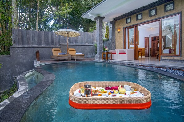 A pool with a floating dining setup.