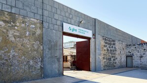 A building with a sign reading "Ayha Fremantle Prison" and a red door. - YHA Fremantle Prison (Fremantle)