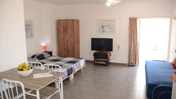 Studio, Patio | Living area | 42-inch flat-screen TV with cable channels, TV