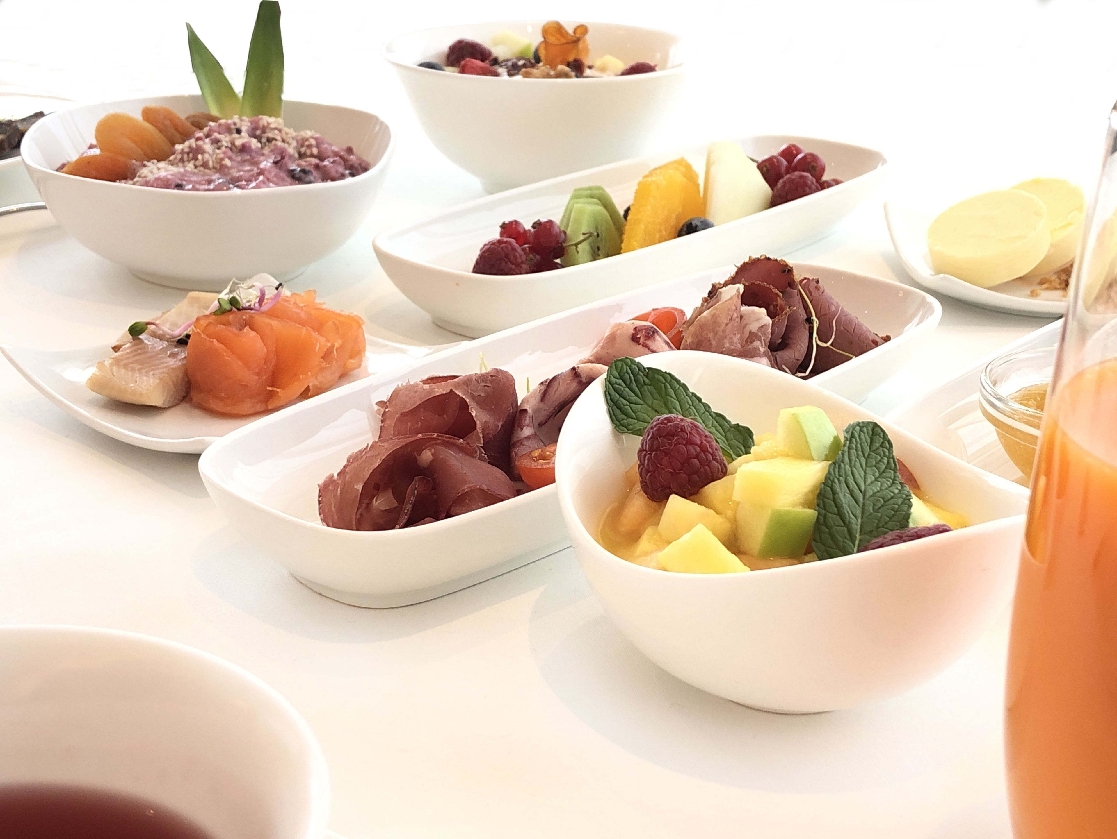 A variety of dishes including fruits, vegetables, and meats arranged on a table.