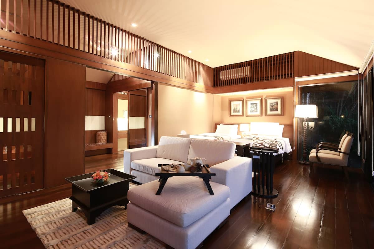 A modern living room with a sofa, a coffee table, and a wooden floor.