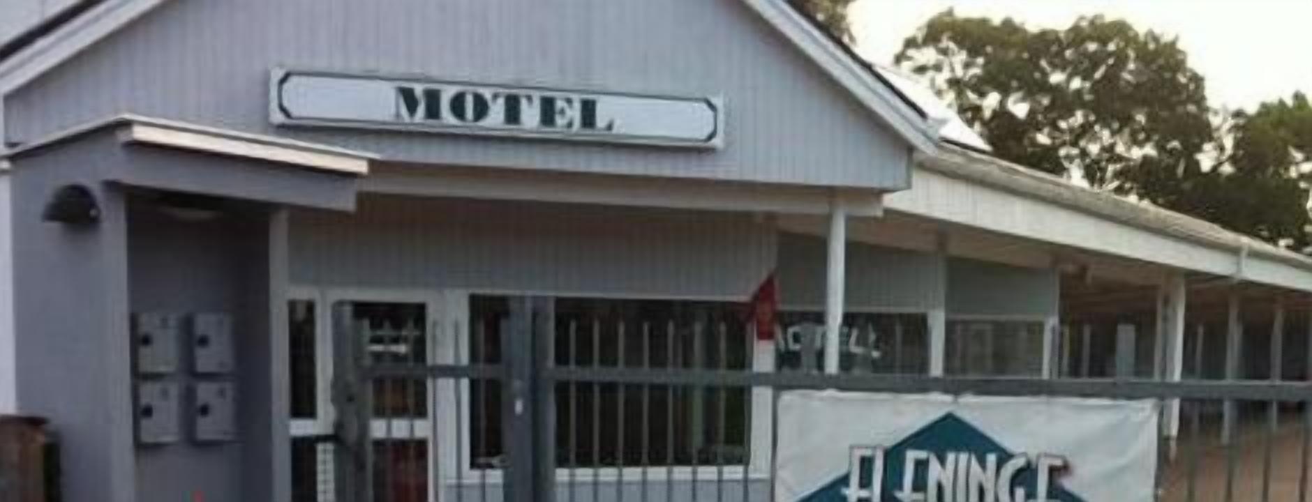 A motel with a signboard labeled "MOTEL" and a banner with "ELNINGE" on the facade.