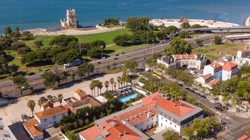 A coastal town with historic architecture, a marina, and a castle.
