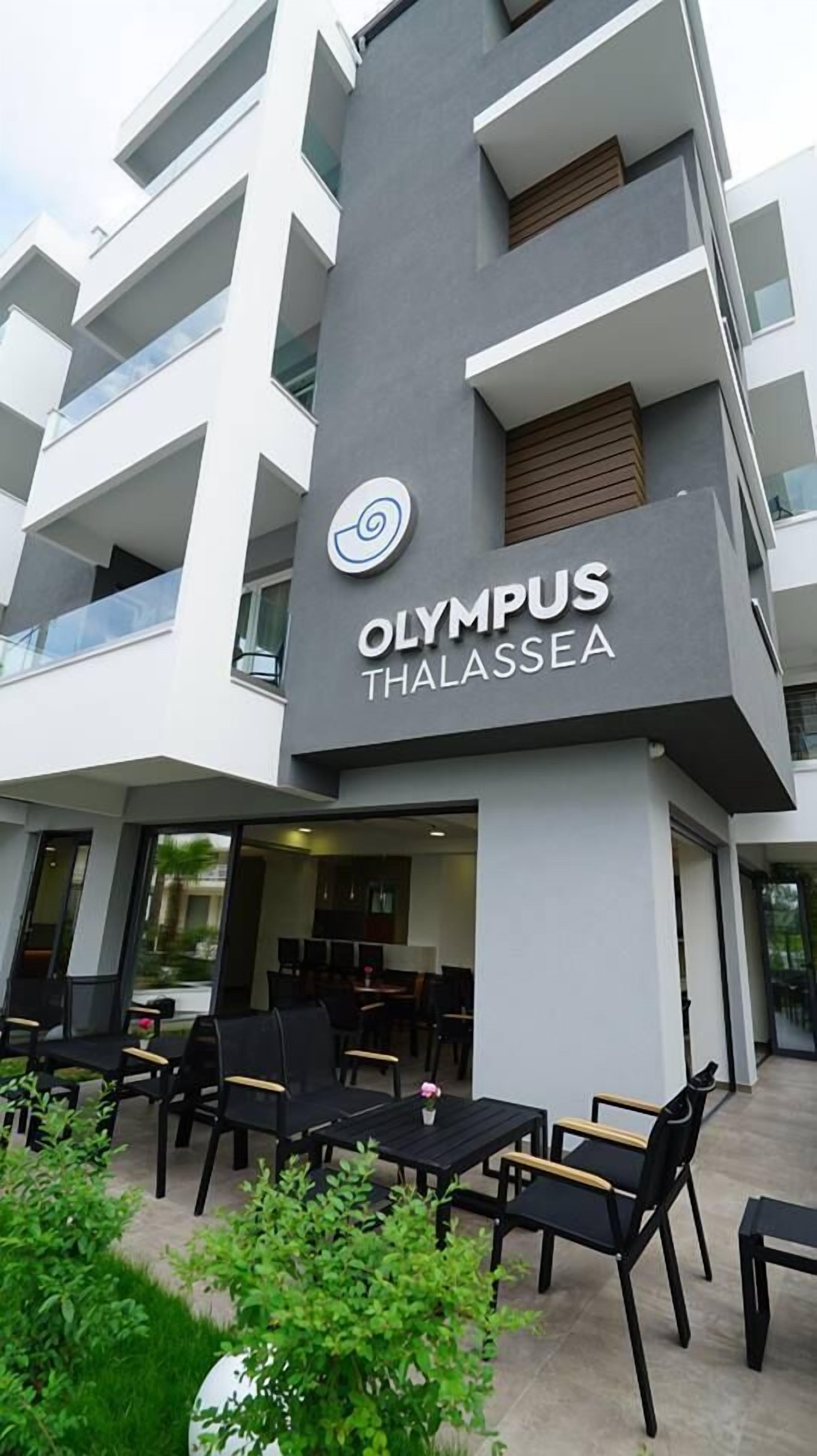 A modern building with the sign "OLYMPUS THALASSEA" indicating a hotel.