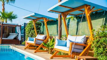 Seasonal outdoor pool, open 11:00 AM to 7:00 PM, free pool cabanas