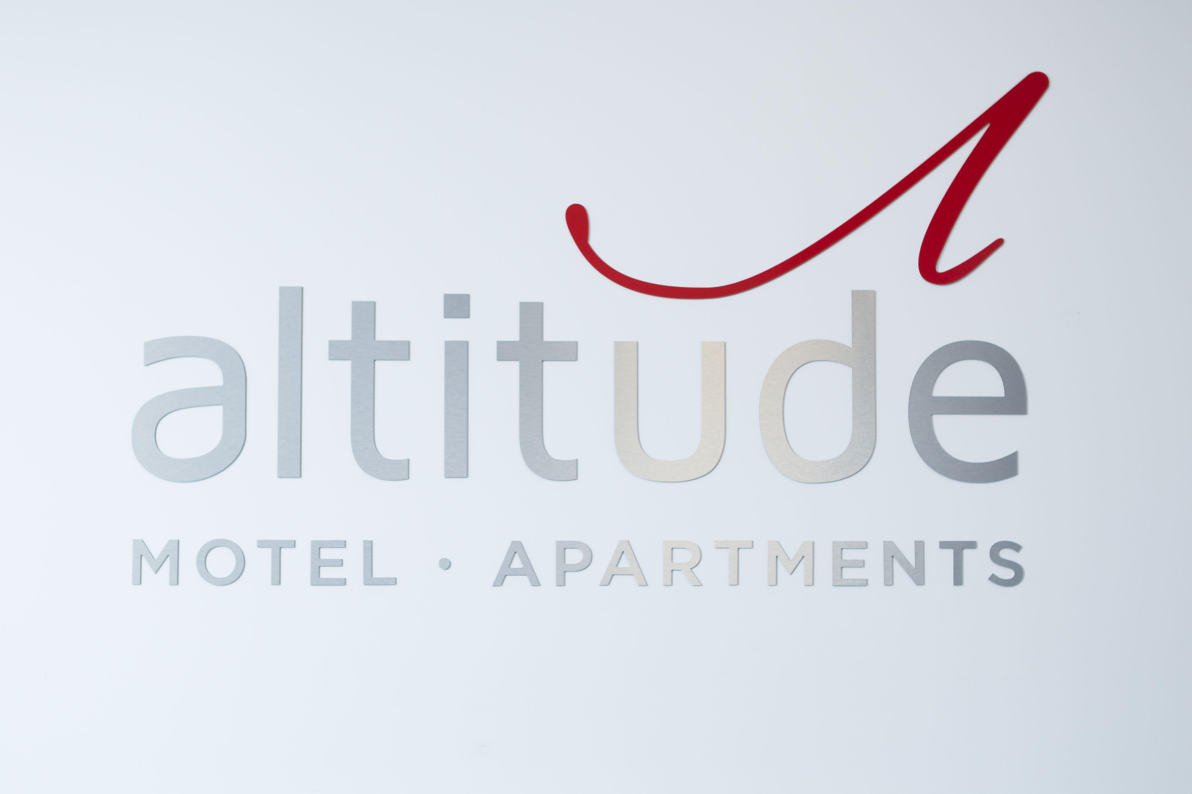 A logo with the word "altitude" and "Motel - Apartments" underneath.