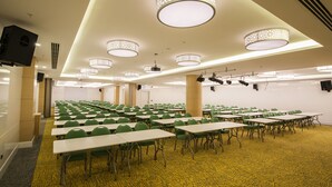 A conference room with multiple tables and chairs, ceiling lights, and a carpeted floor. - Park Inn by Radisson Ankara Cankaya (Ankara)