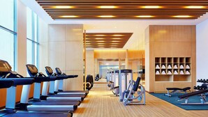 A modern gym with treadmills, weight machines, and benches. - Sheraton Harbin Xiangfang Hotel (Harbin)