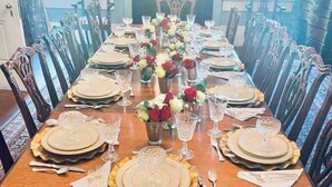 A formal dining room with a long table set for a meal, surrounded by ornate chairs. - Duff Green Mansion (Vicksburg)