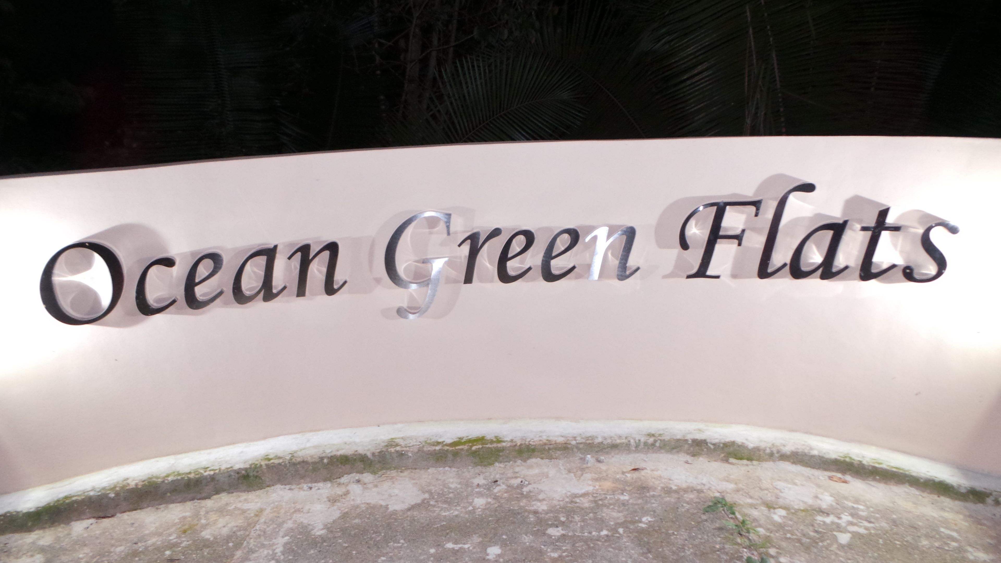 A sign for Ocean Green Flats.