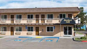 A Budget Inn with a two-story structure, multiple rooms, and a parking lot with handicapped spaces.