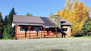 A two-story building with a sign indicating it is a Swiss-Alaska Inn and Rooms Restaurant.