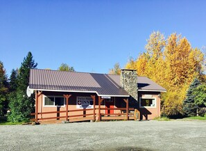 A two-story building with a sign indicating it is a Swiss-Alaska Inn and Rooms Restaurant.