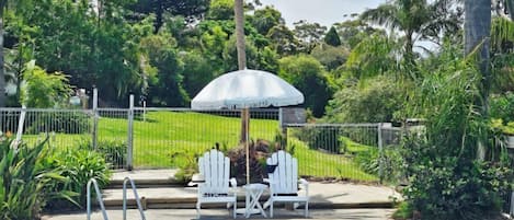 Seasonal outdoor pool, open 8:00 AM to 8:00 PM, pool umbrellas