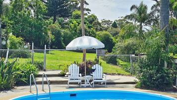Seasonal outdoor pool, open 8:00 AM to 8:00 PM, pool umbrellas