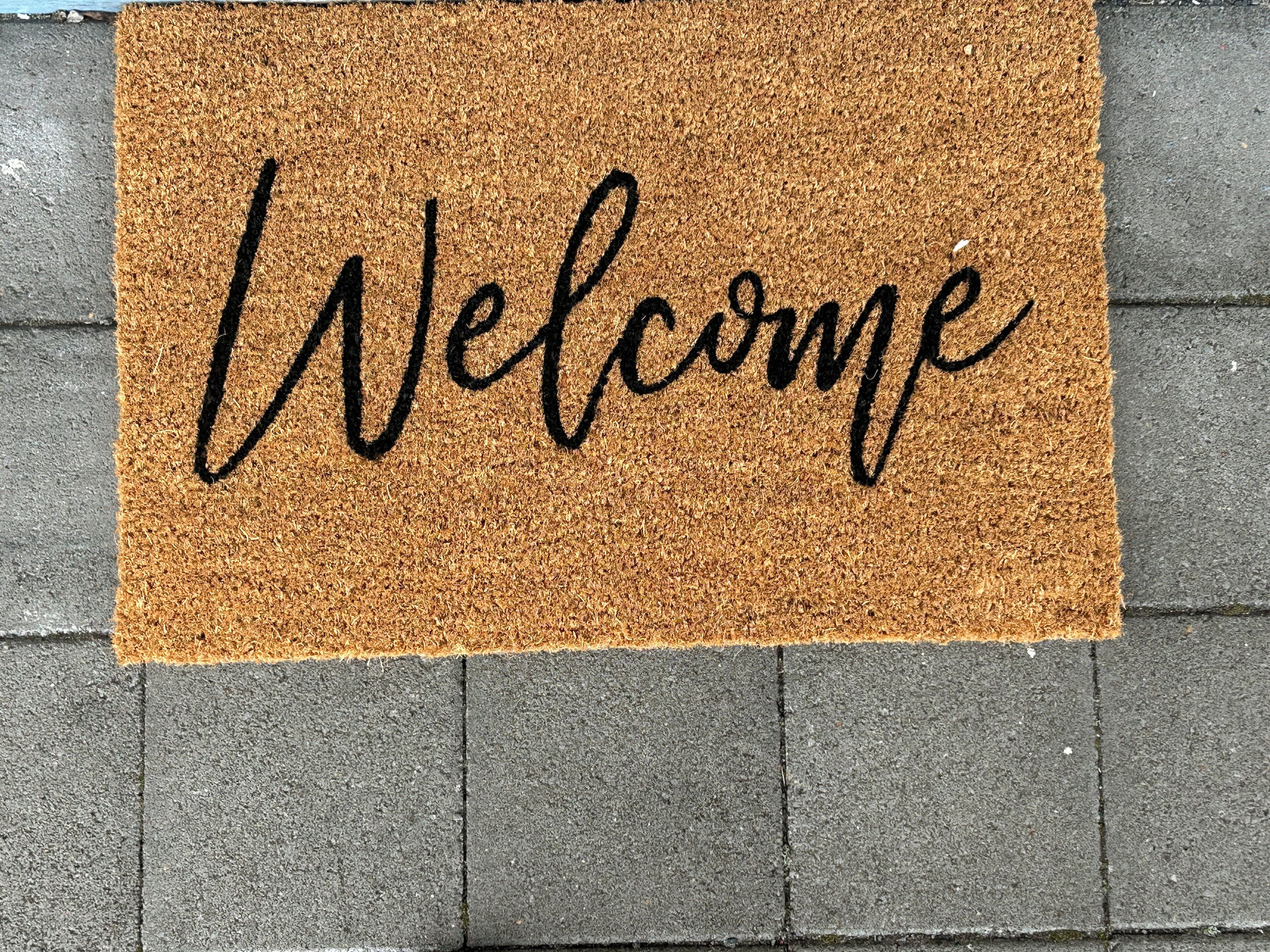A welcome mat with the word "Welcome" written on it.