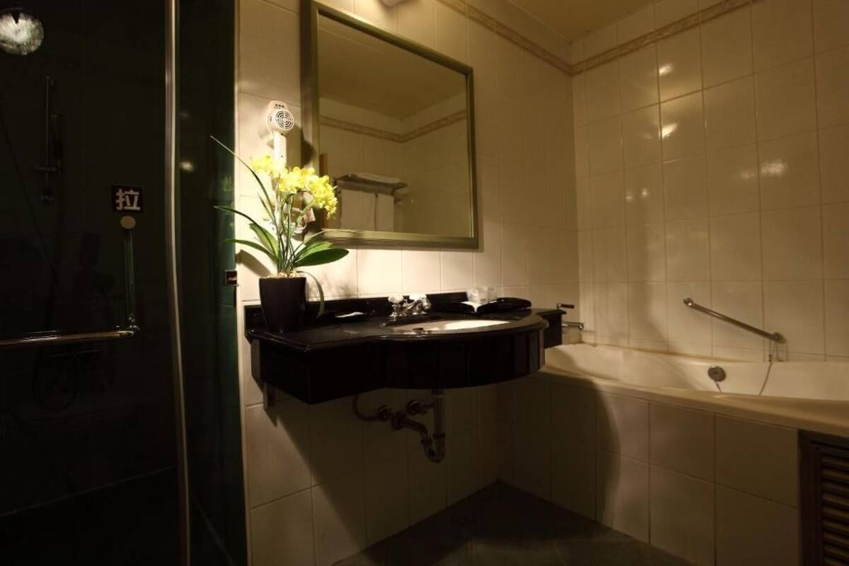 rainfall showerhead, hair dryer, slippers, towels