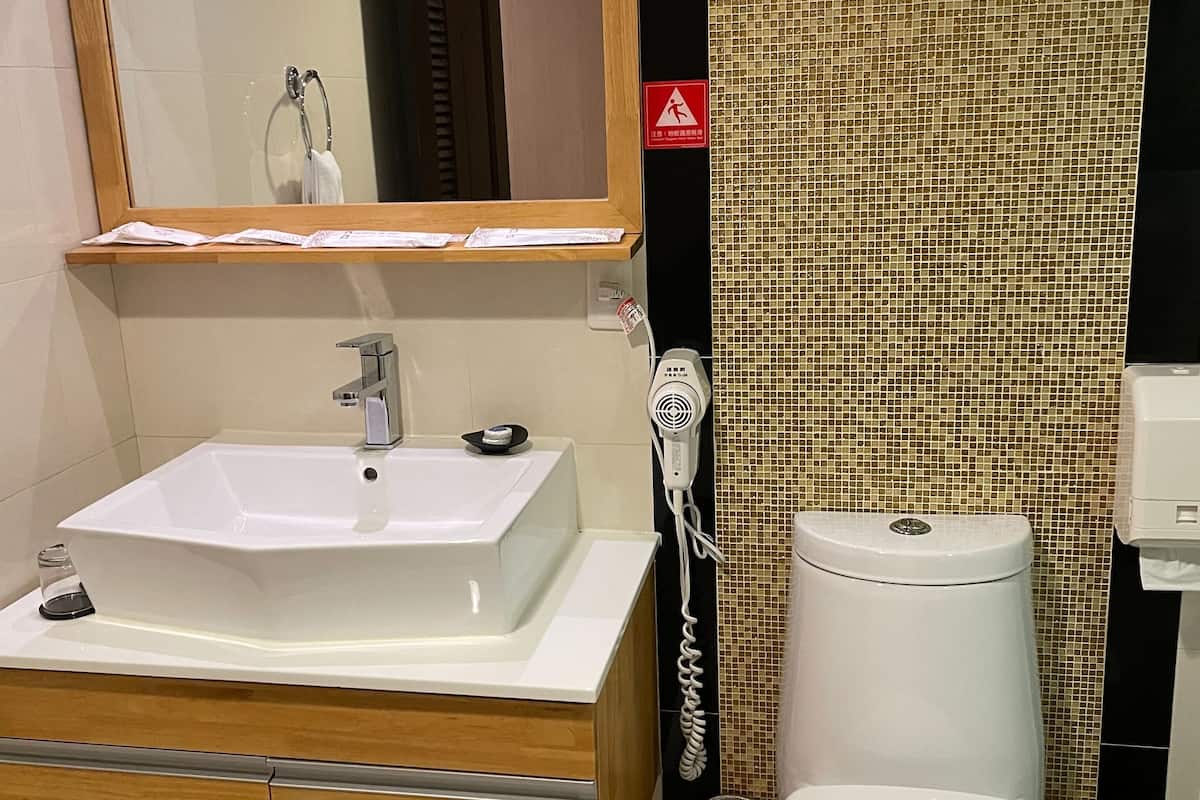 rainfall showerhead, hair dryer, slippers, towels