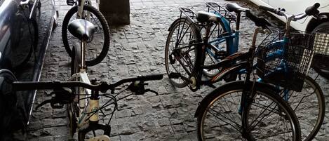 A parking area with bicycles and a car.