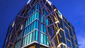 A modern building with a prominent 'ART' sign on the top.