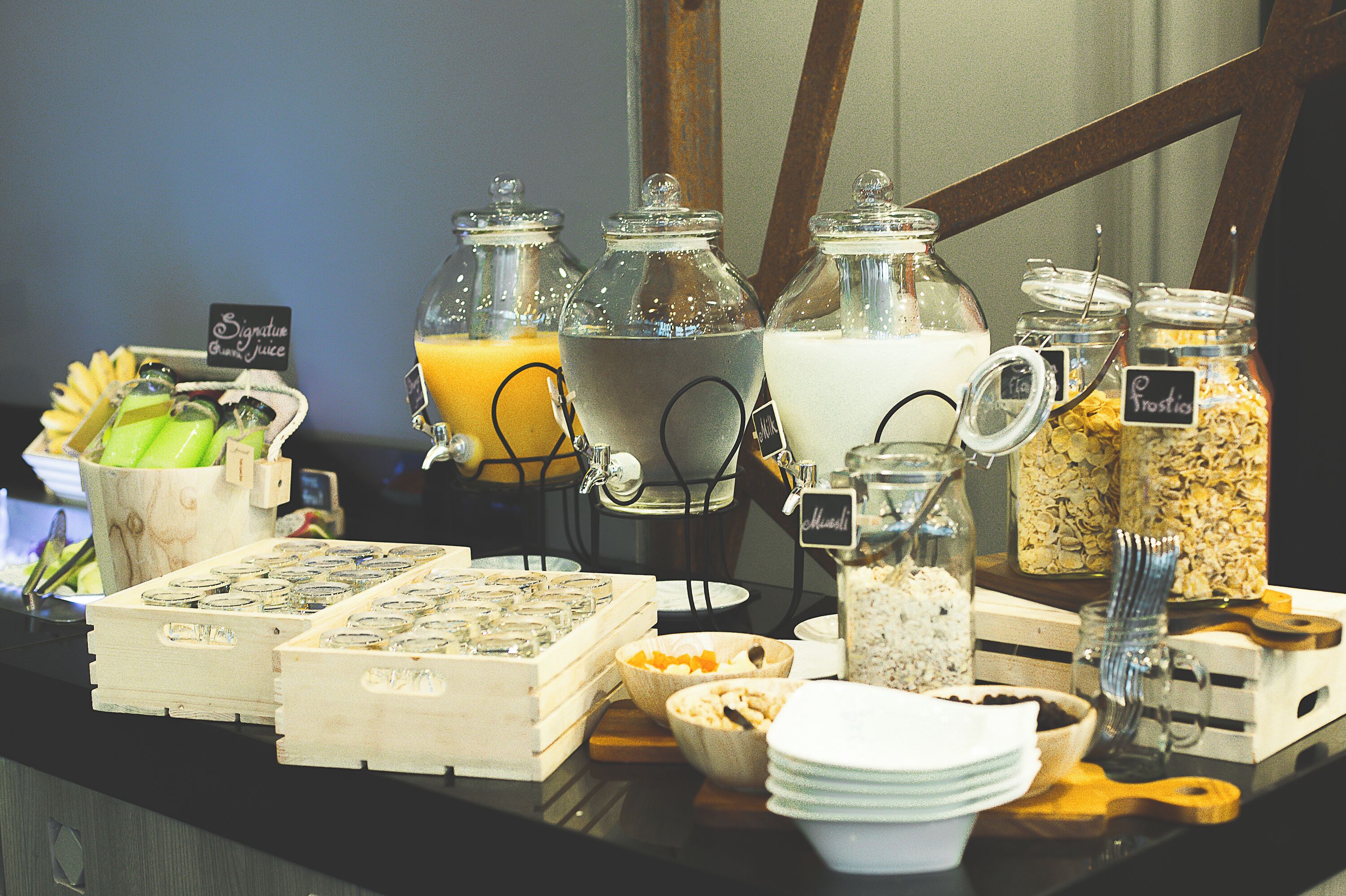 A buffet setup with various food items and beverages.