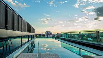 Outdoor pool, open 7:00 AM to 8:00 PM, pool umbrellas, pool loungers