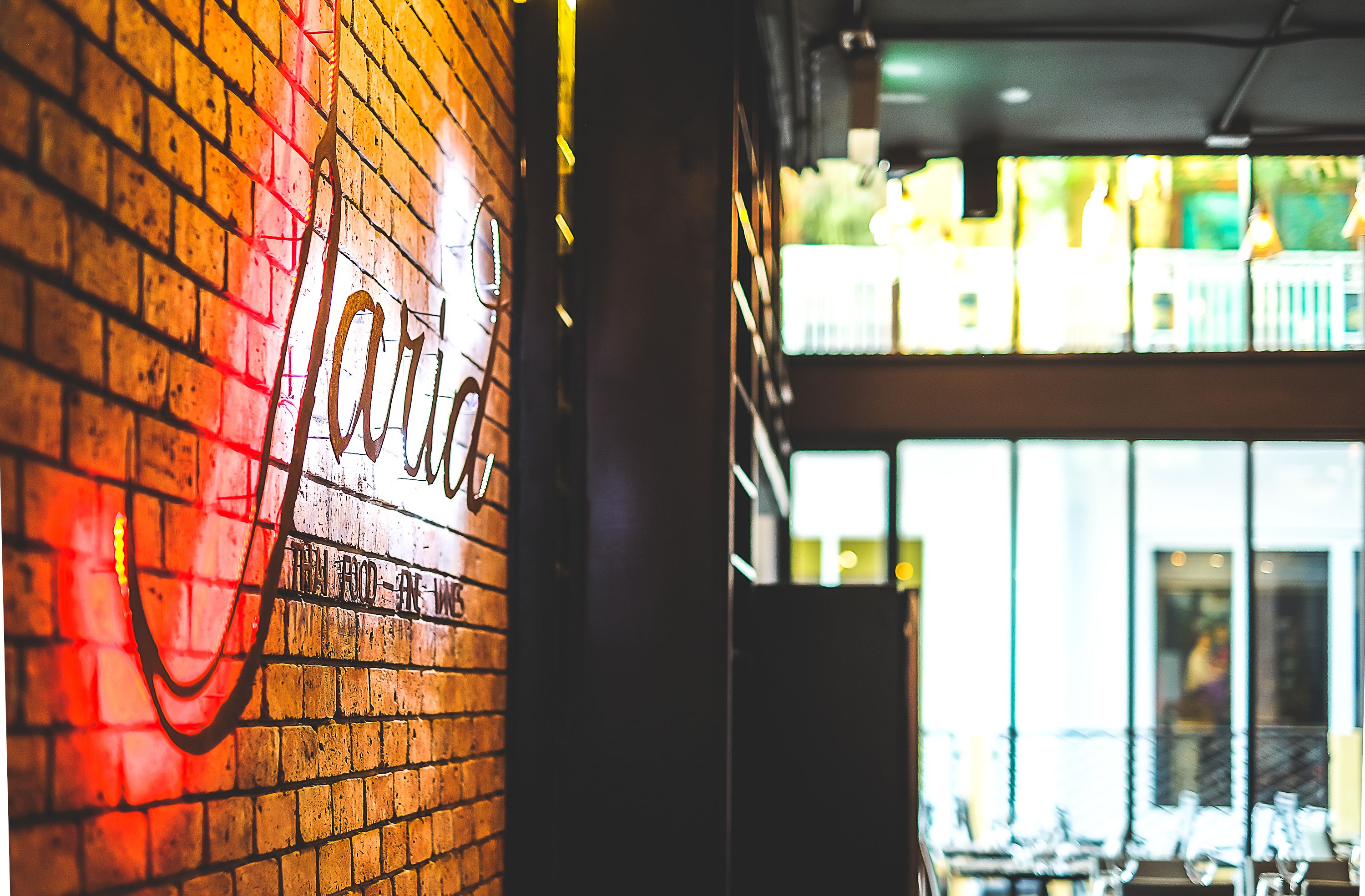 A brick wall with graffiti and a sign that reads "LOFT".