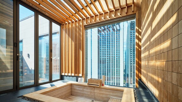 A modern interior with large windows, a wooden bath area, and a view of tall buildings. - Crown Park Hotel Seoul Myeongdong (Seoul)