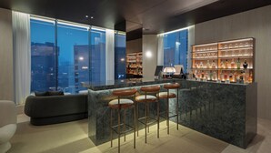 A modern bar area with a marble countertop, bar stools, and a wine display. - Crown Park Hotel Seoul Myeongdong (Seoul)