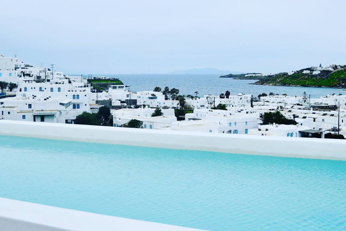 Vista costera con edificios blancos y una piscina.