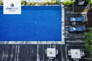 An aerial view of a hotel pool area with a sign reading "COREHOTEL BENOA". - Core Hotel Benoa (Nusa Dua)
