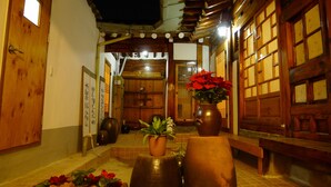 A traditional Japanese interior with wooden sliding doors, tatami flooring, and a central seating area with cushions. - HanOK Guest House 202 (Seoul)