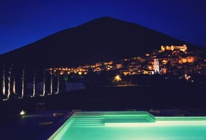 Outdoor pool, a rooftop pool, pool umbrellas, pool loungers