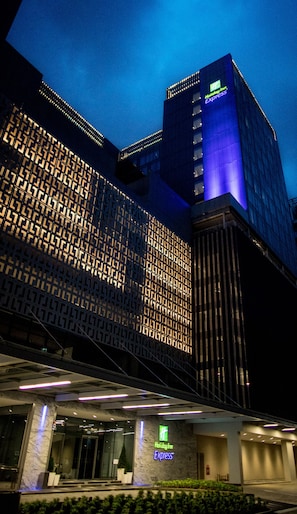 A Holiday Inn Express building with a modern facade, large windows, and a prominent entrance with a sign. - Holiday Inn Express Singapore Katong by IHG (Singapore)