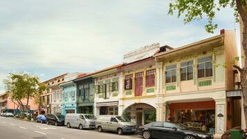 A row of colorful buildings with a variety of storefronts, including a visible sign for a store named 'BRISA'.