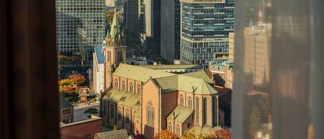 A view of a cityscape with a prominent church and surrounding high-rise buildings.