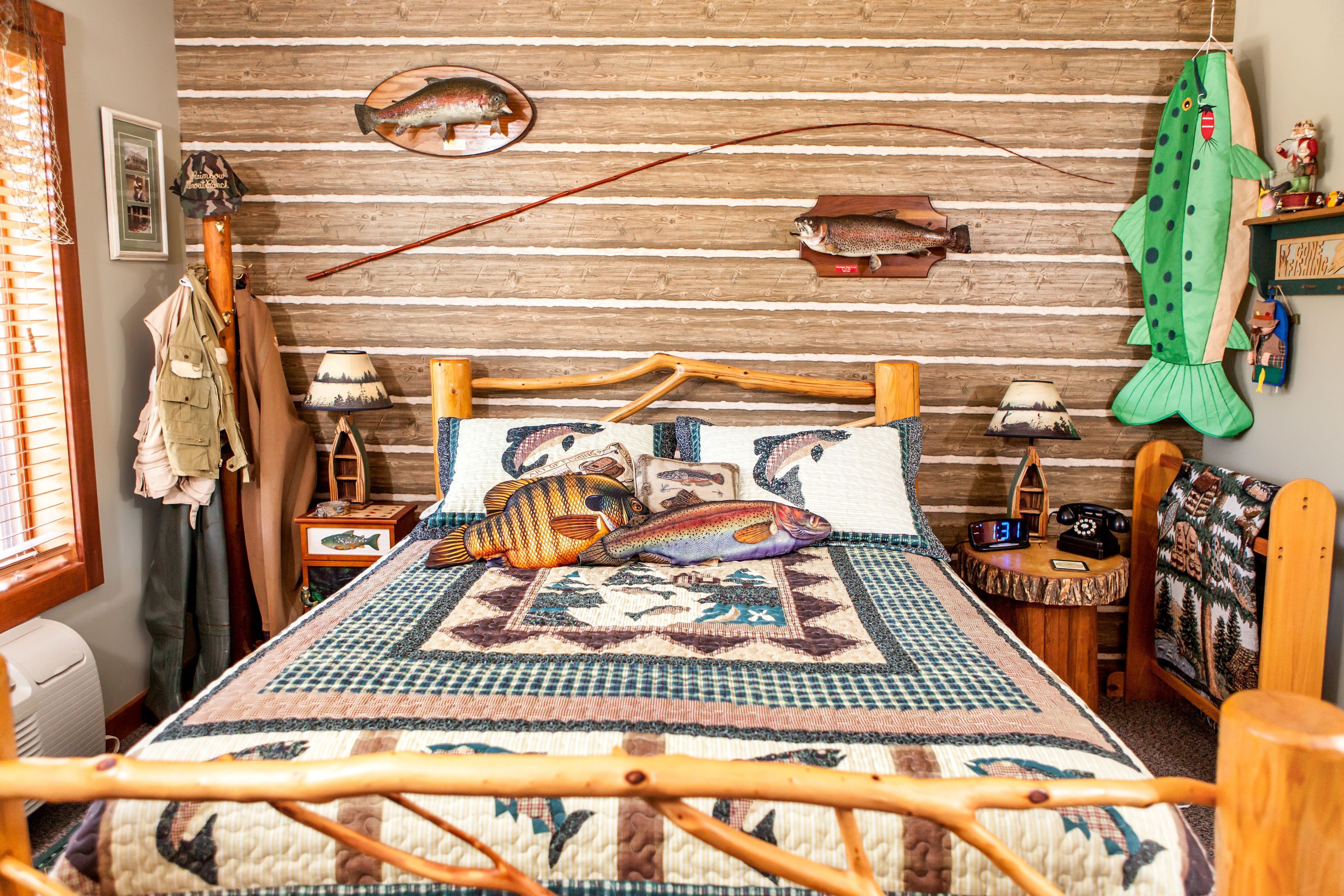 Une pièce chaleureuse avec un lit en bois, une décoration sur le thème de la pêche et une ambiance rustique.