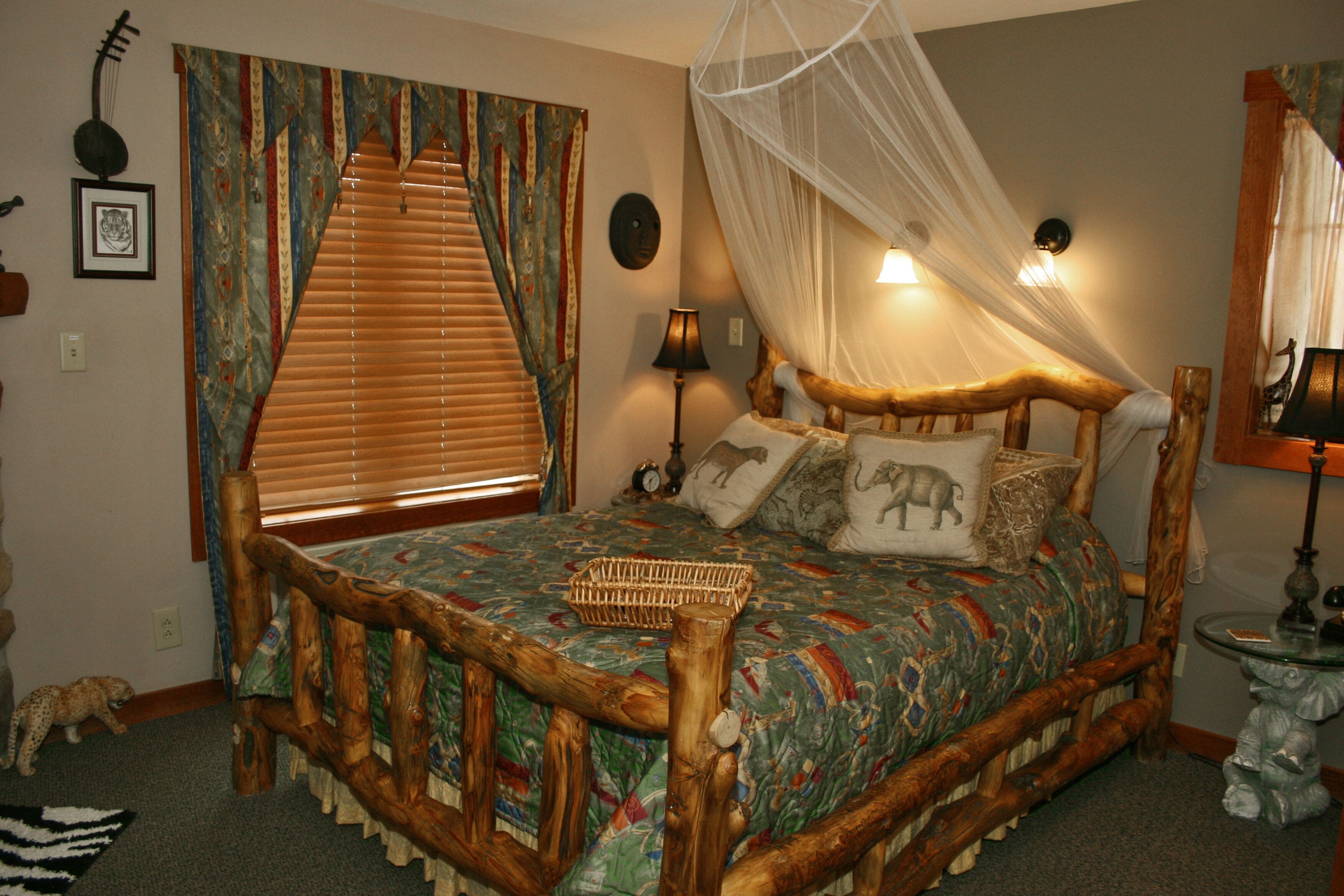 A bed with a wooden frame, a canopy, and decorative pillows.