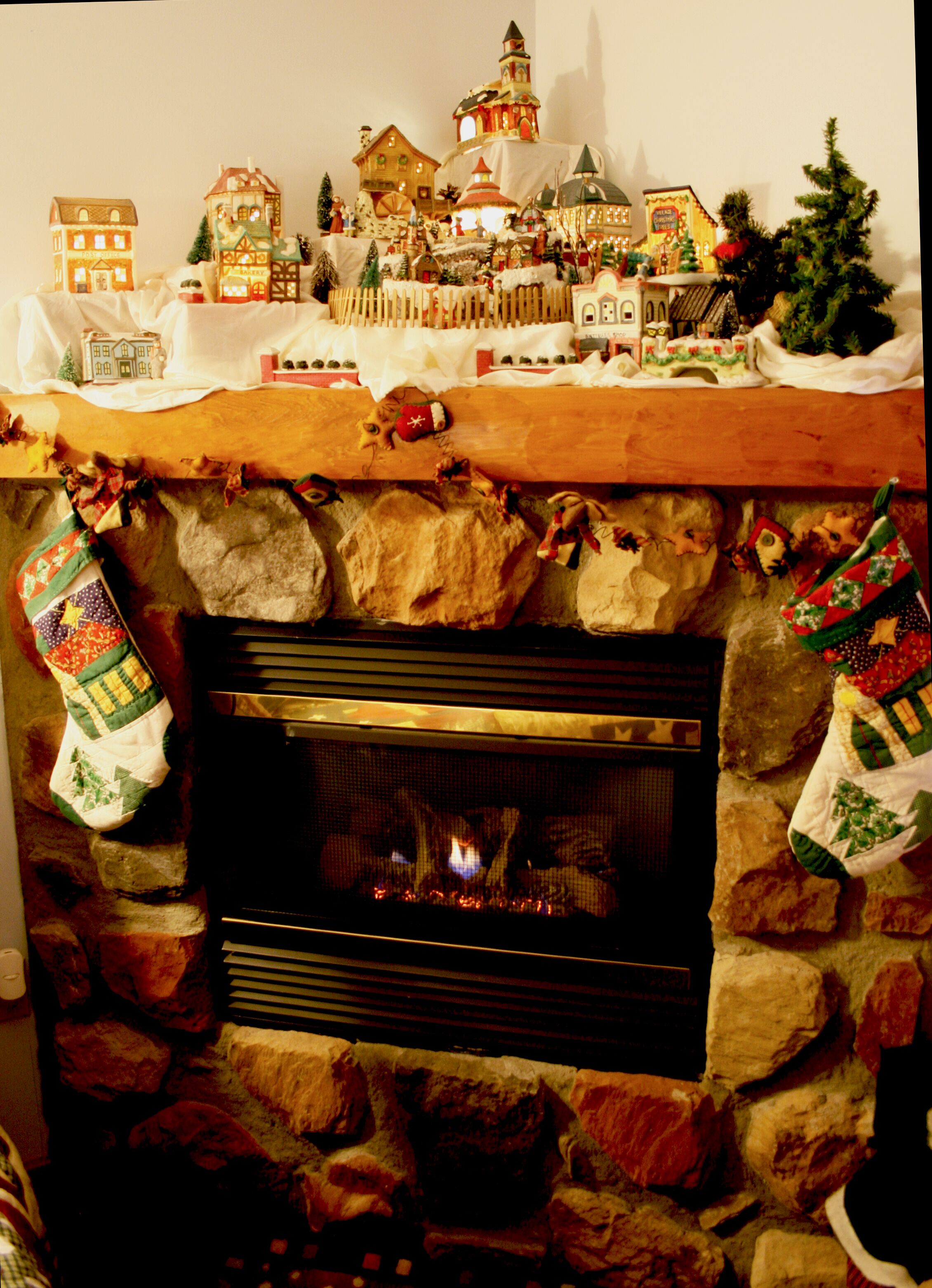 A fireplace with stockings hanging on either side.