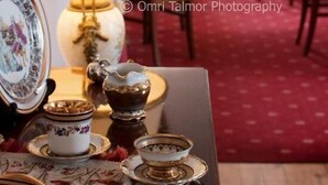 A room with a table set for dining, featuring a lamp, a framed picture, and various decorative items. - Konstantinoupolis Hotel - Adults friendly (Corfu)
