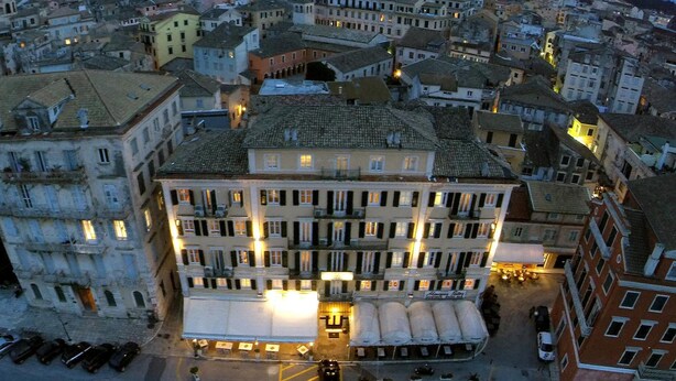 A multi-story hotel with a central courtyard, surrounded by other buildings. - Konstantinoupolis Hotel - Adults friendly (Corfu)