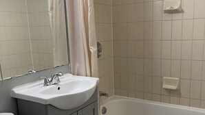 A bathroom with a sink, toilet, and bathtub.