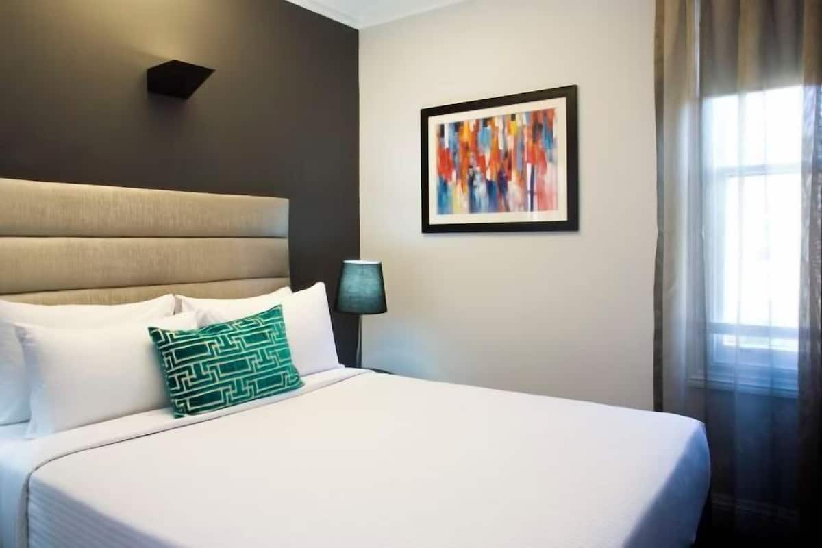 Premium bedding, desk, laptop workspace, blackout drapes