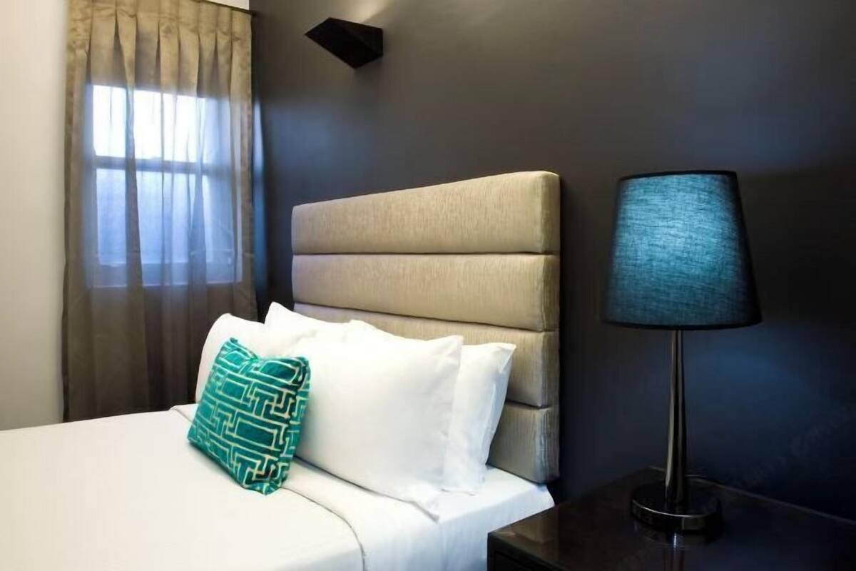 Premium bedding, desk, laptop workspace, blackout drapes