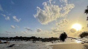 A beach with a clear sky, calm sea, and a sunset. - Elysium (Unawatuna)