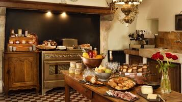A kitchen with a checkered floor, wooden cabinets, a stove, and various food items on the counter.