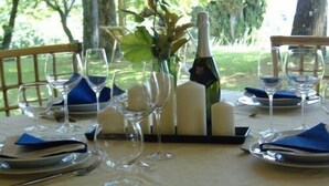A table set for a meal with wine glasses, a bottle, and candles. - B&B da Ronald...a Pian del Papa (Pratovecchio Stia)