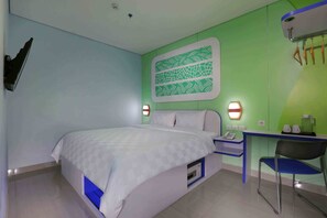 A hotel room with a bed, bedside table, chair, and a wall-mounted artwork. - Cordex Hotel Ancol Jakarta (Jakarta)
